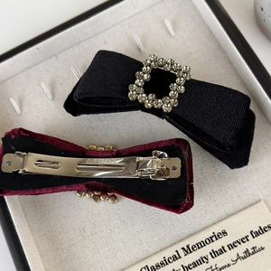 Macro detail of high-quality metal spring clip and exquisite fabric texture on bow hair clip