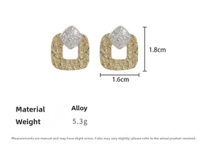 Detailed view of square relief earrings in dual-tone alloy with irregular texture and dimensions