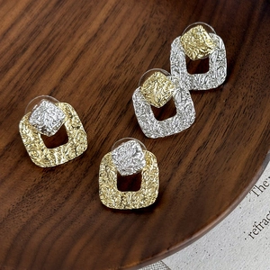 Vintage metal stud earrings with irregular hammer texture in gold and silver mixed tones