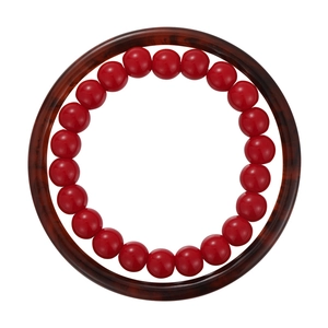 Set of dark red beaded bracelet and amber tortoiseshell resin bangle on white background