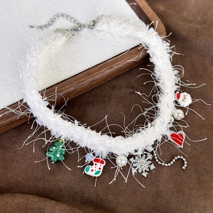 Close-up of plush Christmas choker featuring festive charms like snowflakes and pearls