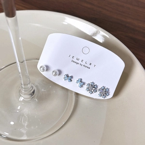 6-piece set of snowflake pearl and bowknot earrings displayed on a white jewelry card