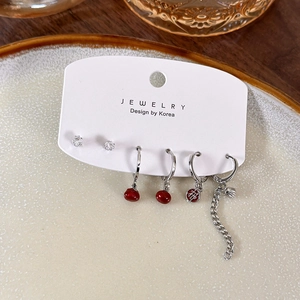 Six-piece set of red and silver earrings featuring Chinese charms on a white jewelry card