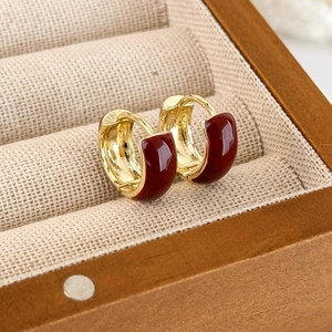 French vintage style gold-plated hoop earrings with dark red enamel inlay in a jewelry box