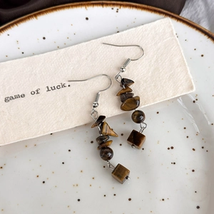 Detailed view of vintage tiger eye stone drop earrings with brown mineral textures