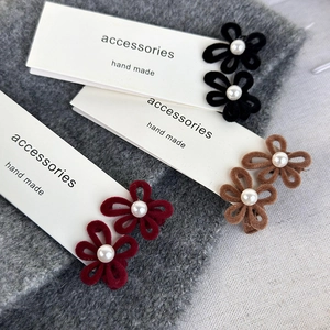 Three velvet floral hair clips with pearls in black, brown, and burgundy colors