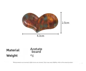 Detail view of heart acetate hair clip with dimensions 4.3cm by 2.5cm and tortoise texture
