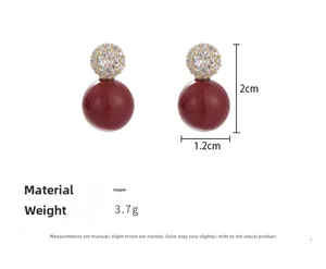 Dettaglio orecchini vintage con perle rosse e zirconi con misure indicate di 2cm per 1,2cm