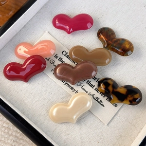 Chic acetate heart-shaped hair clips in various colors like tortoiseshell and pink