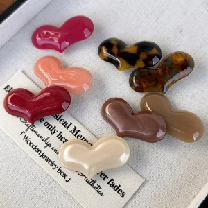 Set of colorful acetate heart hair clips in red, pink, and tortoiseshell patterns