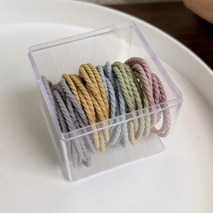 Close-up of Morandi colored high-elastic hair ties in a clear square storage box