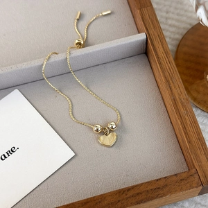 Elegant gold heart pendant bracelet with cat eye stone and adjustable sliding chain clasp