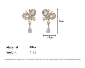 Detailed view of rhinestone butterfly drop earrings with size measurements 3cm by 1.9cm