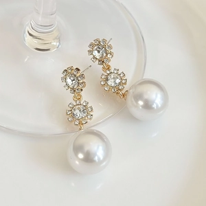 Elegant vintage long gold dangle earrings with sparkling floral studs and large round pearls