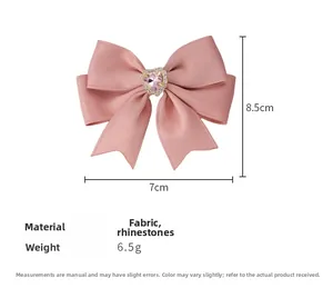 Detail showing pink rhinestone heart bow hair clip with dimensions 8.5cm by 7cm