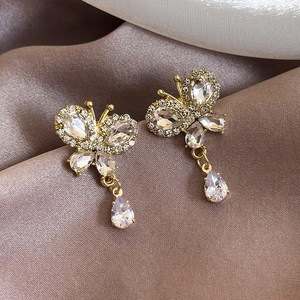 Elegant gold butterfly earrings with sparkling cubic zirconia and teardrop tassel pendants