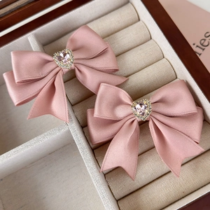 Pink ribbon bow hair clips with heart rhinestone detail in premium velvet jewelry box