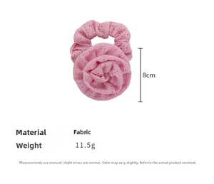 Detailed view of pink fabric scrunchie featuring 3D rose flower design and 8cm size mark