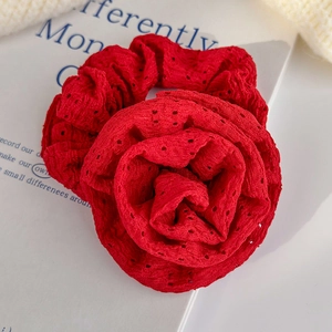 Detailed macro view of the vivid red lace rose hair scrunchie with intricate petal textures