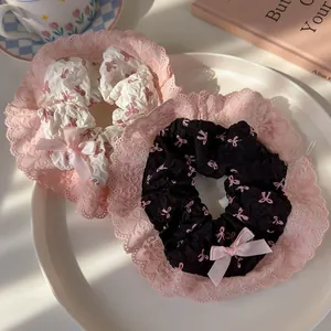 Close-up of pink bow lace hair scrunchies on a white plate with aesthetic lifestyle props