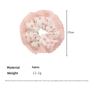 Detail view of pink lace scrunchie with floral pattern and ribbon bow, 17cm diameter
