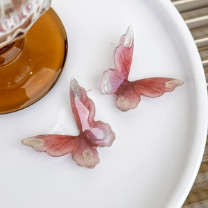 Pink gradient resin butterfly stud earrings with sparkling gold and silver glitter accents