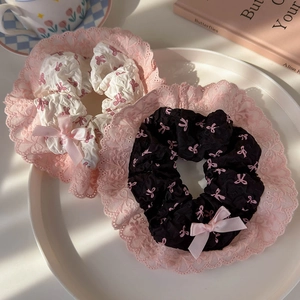 Detail of pink bow pattern scrunchies with elegant lace trim in black and cream