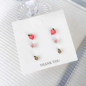 Pink peach and flower stud earring set with gold accents for women on a display card