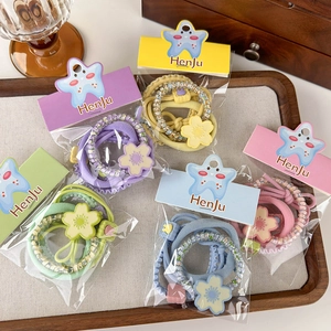 Set of colorful elastic hair ties with flower charms in pastel candy colors for women