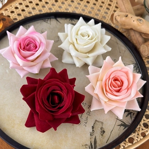 Vintage artificial rose hair clips in deep red, pink, and ivory for elegant hairstyling
