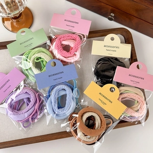 Dettaglio del set di elastici per capelli multicolore in confezioni fatte a mano