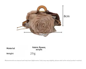 Detail view of large 13cm vintage caramel rose hair claw clip made of fabric and acrylic