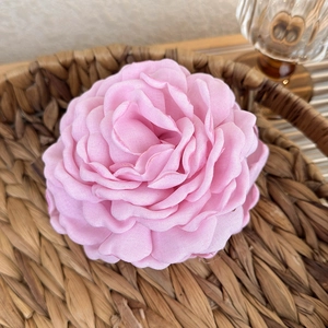 Close-up of pink fabric dried rose hair claw clip with multi-layered textile petals