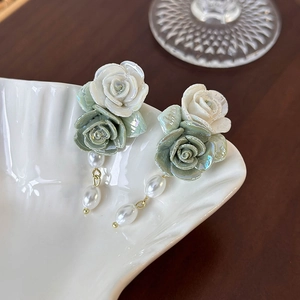 Vintage green and cream ceramic rose flower earrings with pearl drops on shell dish