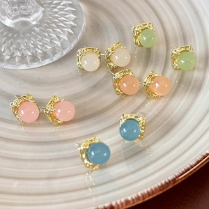 French vintage square gold studs with colorful translucent beads set on a beige plate