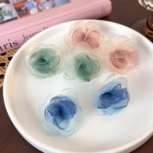 Ethereal mesh flower earrings in multiple colors on a ceramic plate for women