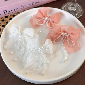 Elegant chiffon bow earrings with crystal tassel and pearl accents in white and pink