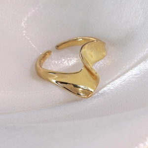 Detailed macro view of the liquid metal wave pattern on this gold adjustable open ring