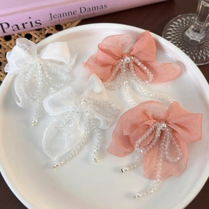 Elegant organza bow earrings with crystal tassel fringe and pearl accents in soft colors