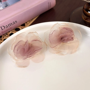 Elegant 3D mesh flower earrings in soft pink organza on a decorative white porcelain plate