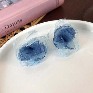Detailed macro of gradient blue mesh flower earrings with layered lightweight tulle petals