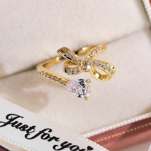 Vue macro d'une bague papillon dorée avec zircons micro-pavés et pierre en poire