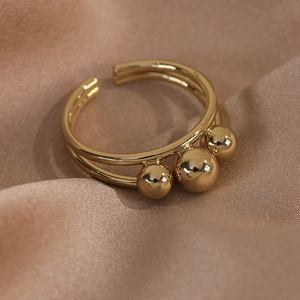 Detail shot of a minimalist double-layer gold open ring featuring three metal beads decor