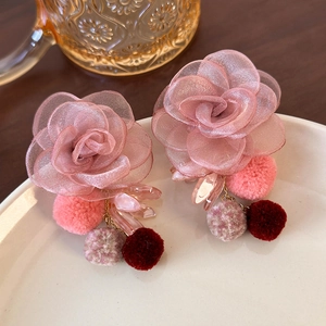 Detail of pink organza flower earrings with soft pom-poms and clear acrylic petals