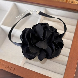 Detail of handmade 3D black fabric flower choker necklace with adjustable metal chain