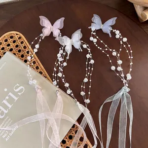 Elegant butterfly pearl tassel necklaces in pink, white, and blue with silk ribbons