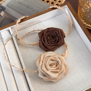 Detail of elegant satin rose choker with wavy ribbon and adjustable metal clasp