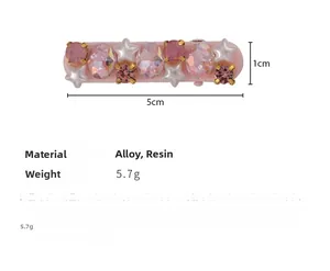Detailed view of pink rhinestone star hair clip with 1cm x 5cm dimension marks
