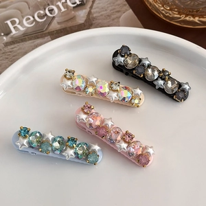 Star-shaped hair clips with colorful rhinestones and pearls in pink and blue