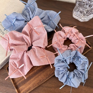 Detailed texture of cotton linen bow scrunchies in sky blue and cherry pink colors